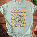 Green monster graphic on a light blue t-shirt with "EVERYDAY MY HEAD GOES" and rows of "A"s.