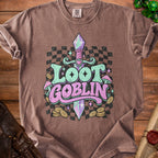 Brown t-shirt with "Loot Goblin" text, sword, mushrooms, coins, and checkered background.