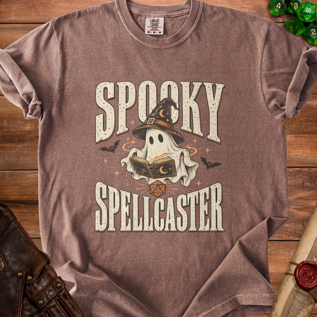 Brown t-shirt with "Spooky Spellcaster" text, ghost wearing a witch hat, and dice.