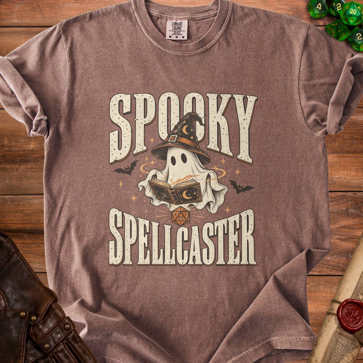Brown t-shirt with "Spooky Spellcaster" text, ghost wearing a witch hat, and dice.