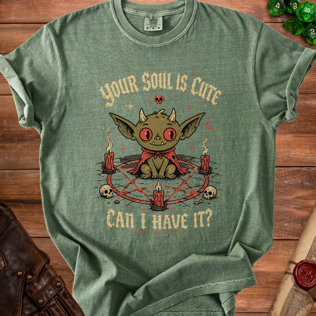 Green t-shirt with cartoon demon, pentagram, skulls, and text "YOUR SOUL IS CUTE CAN I HAVE IT?".