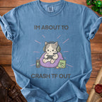 Blue t-shirt with cartoon cat wearing headphones gaming and text "I'M ABOUT TO CRASH TF OUT".