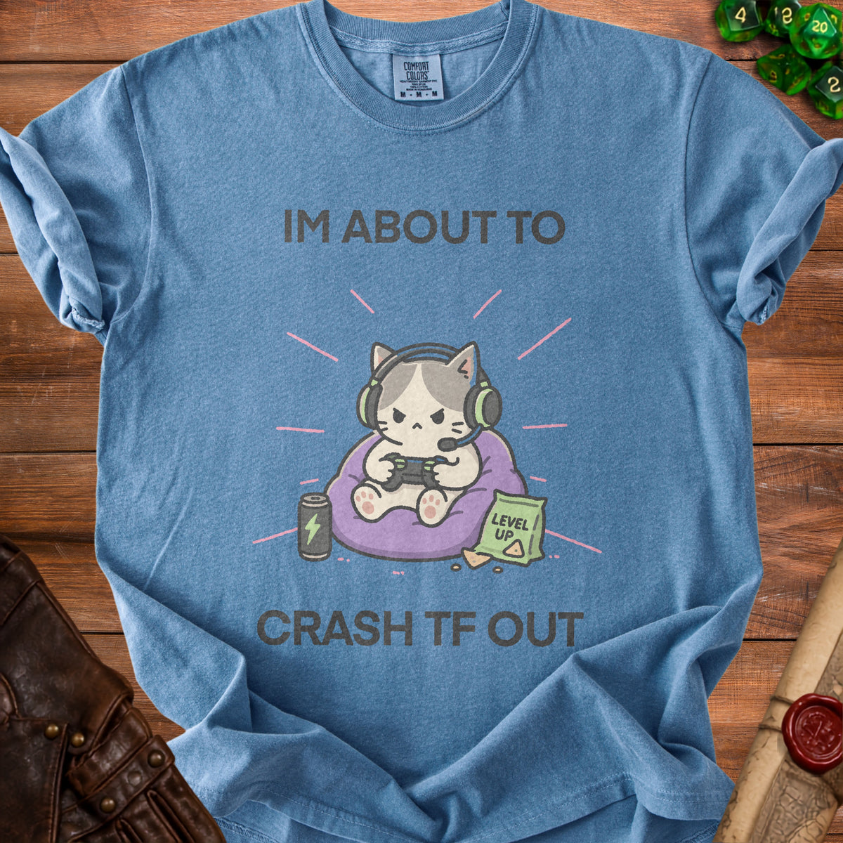 Blue t-shirt with cartoon cat wearing headphones gaming and text "I'M ABOUT TO CRASH TF OUT".