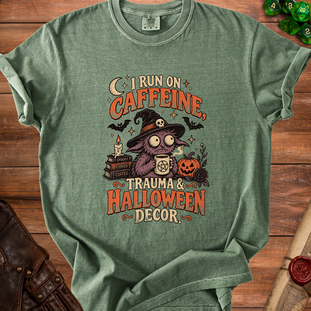 Green t-shirt with "I run on caffeine, trauma, and Halloween decor" text and spooky monster.