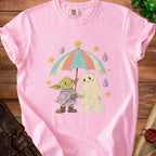 Pink t-shirt with baby Yoda and ghost characters sharing an umbrella.
