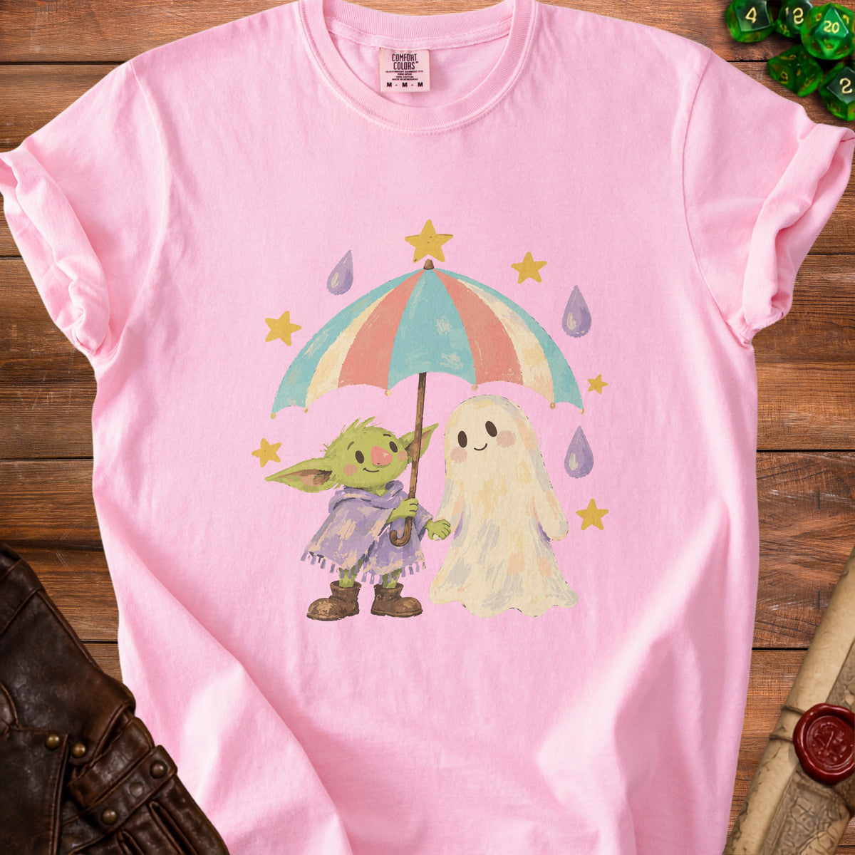 Pink t-shirt with baby Yoda and ghost characters sharing an umbrella.