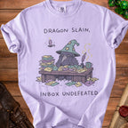 Light purple t-shirt with a raven wizard illustration and text "Dragon Slain, Inbox Undefeated".