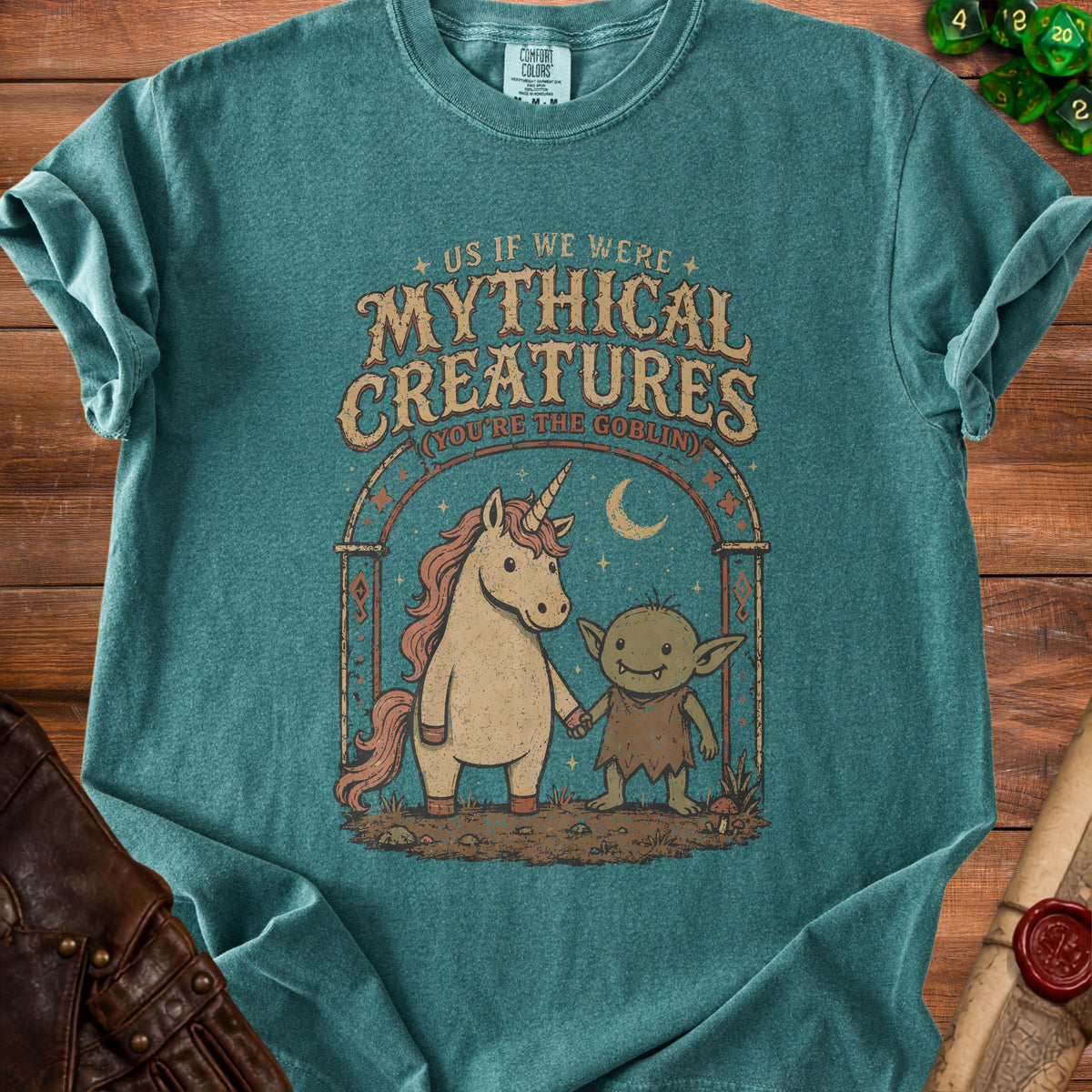 T-shirt with graphic of unicorn and goblin holding hands, "Mythical Creatures" text.