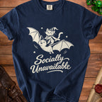 Navy t-shirt with white graphic of a cat riding a bat, text "Socially Unavailable".