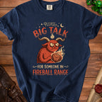 Navy t-shirt with a red monster holding a d20 die, text reads "Please. Big Talk. For Someone In Fireball Range."