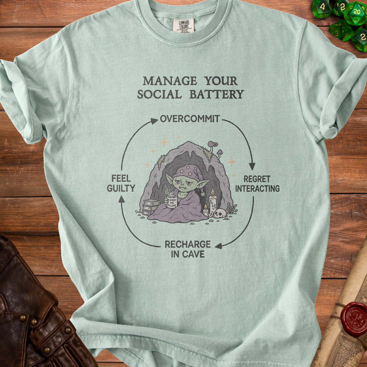 T-shirt graphic showing a cycle of social battery management with text and illustrations.