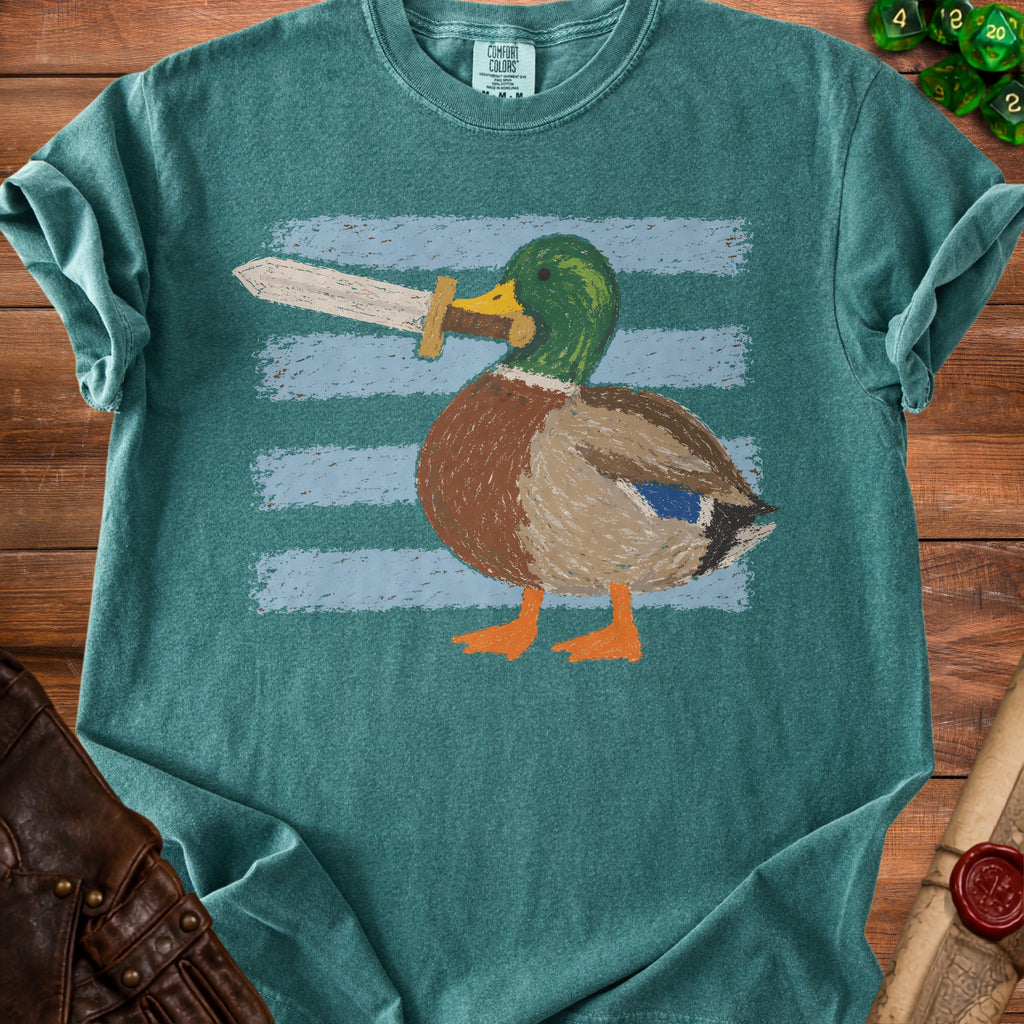 Mallard duck with a sword in its beak, on a teal shirt.