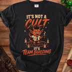 Black t-shirt with text "It's Not A Cult, It's Team Building" and cartoon devil.