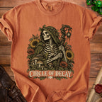 Skeleton in cloak with staff and nature elements, "Circle of Decay" text.