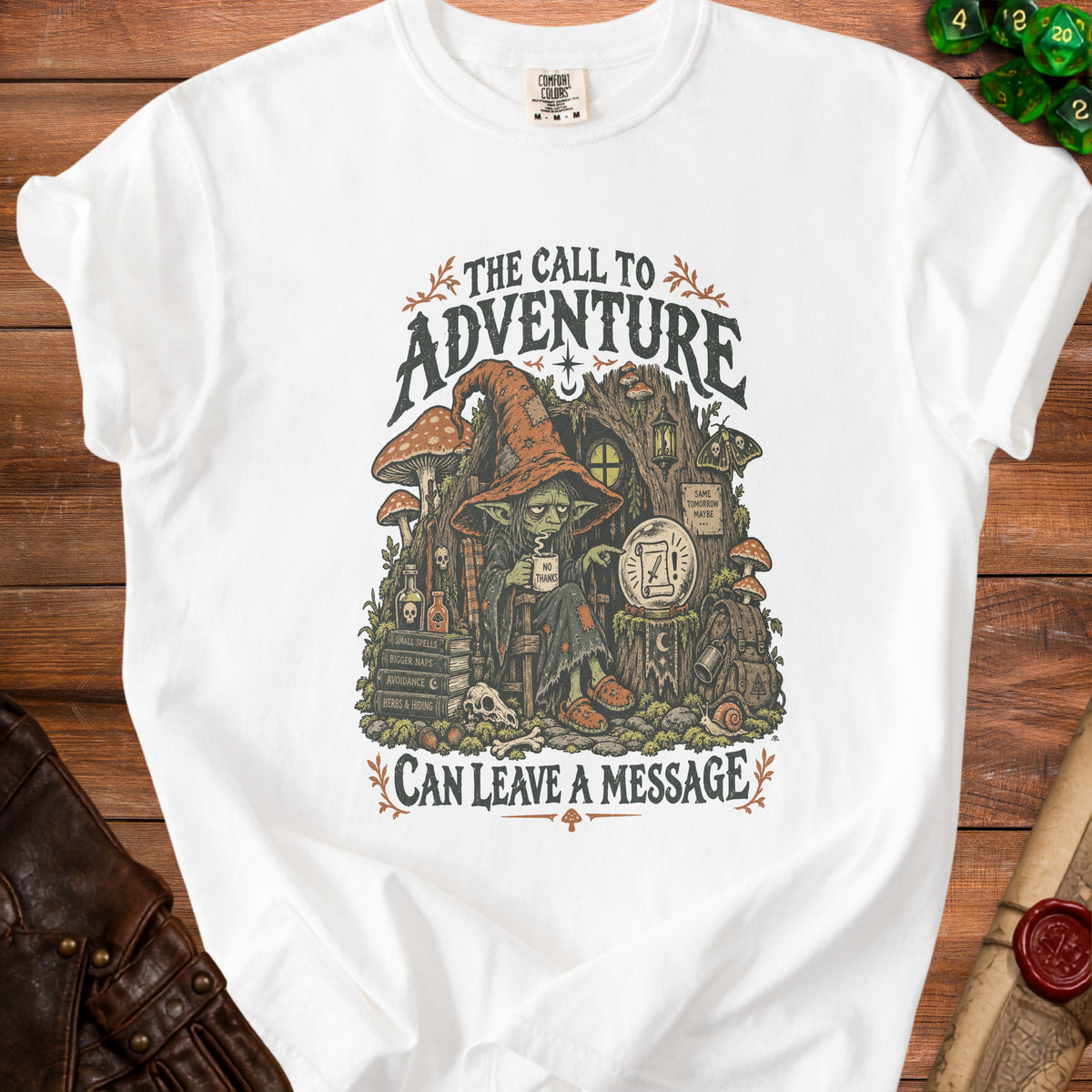 White t-shirt graphic featuring a goblin with a sign that reads "Can Leave a Message".
