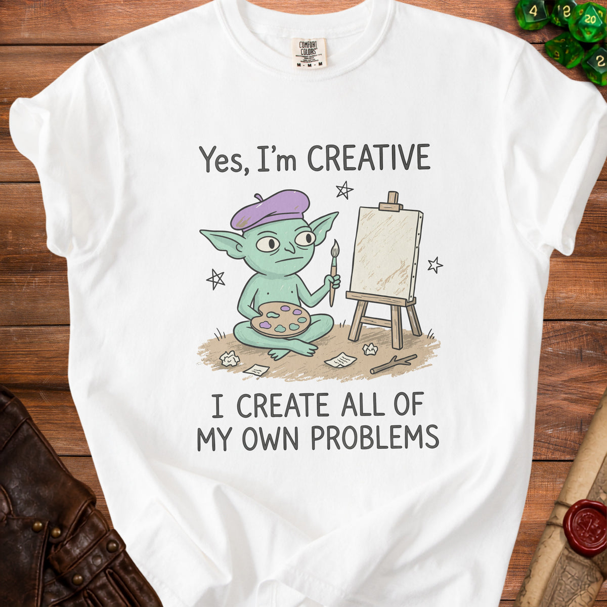 White t-shirt with a cartoon goblin artist and the text "Yes, I'm CREATIVE I CREATE ALL OF MY OWN PROBLEMS".