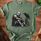 T-shirt with knight and raven graphic and "IT KNOWS" text.