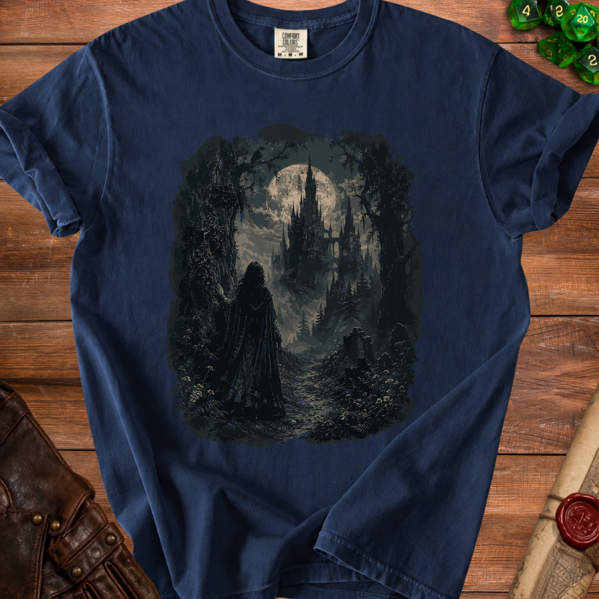 Dark t-shirt graphic of a cloaked figure walking toward a gothic castle under a full moon.