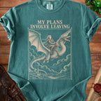 Teal t-shirt featuring a beige graphic of a woman riding a flying dragon above a castle, with the text MY PLANS INVOLVE LEAVING.