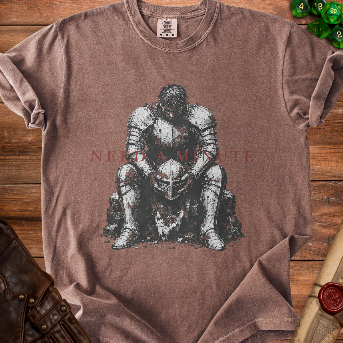 T-shirt with artwork of a knight holding helmet, text "NEED A MINUTE".