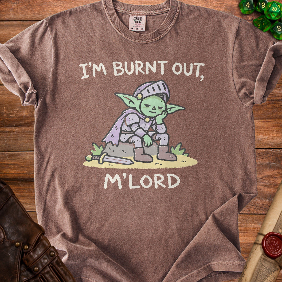 Brown t-shirt with cartoon goblin knight saying "I'M BURNT OUT, M'LORD".
