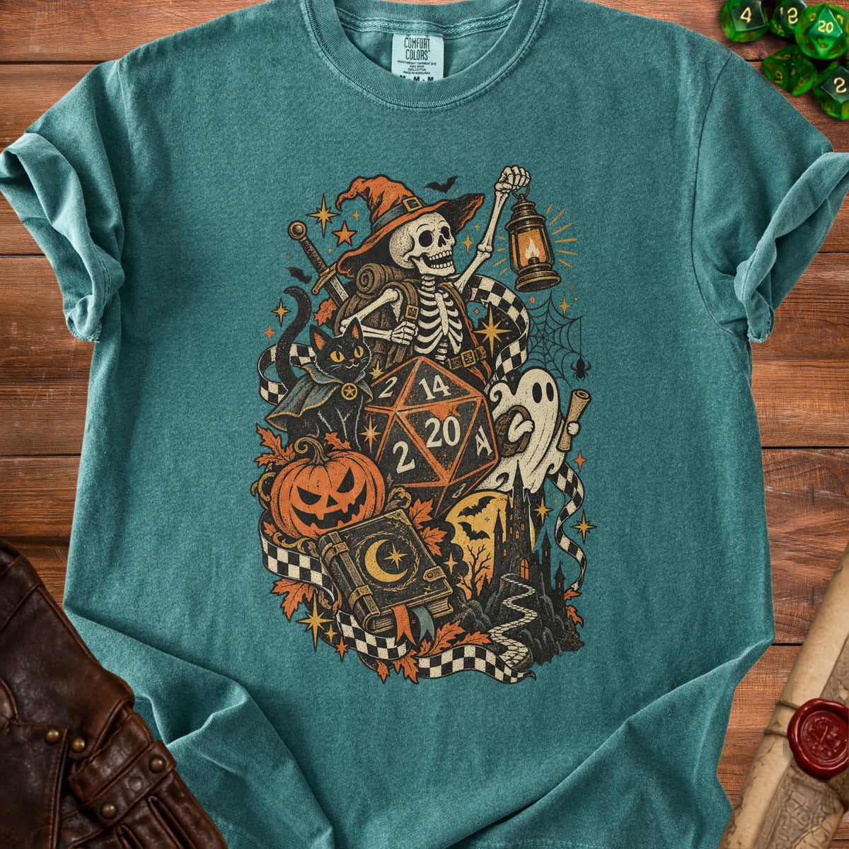 Skeleton adventurer with dice, pumpkin, cat, and ghost on a teal t-shirt.