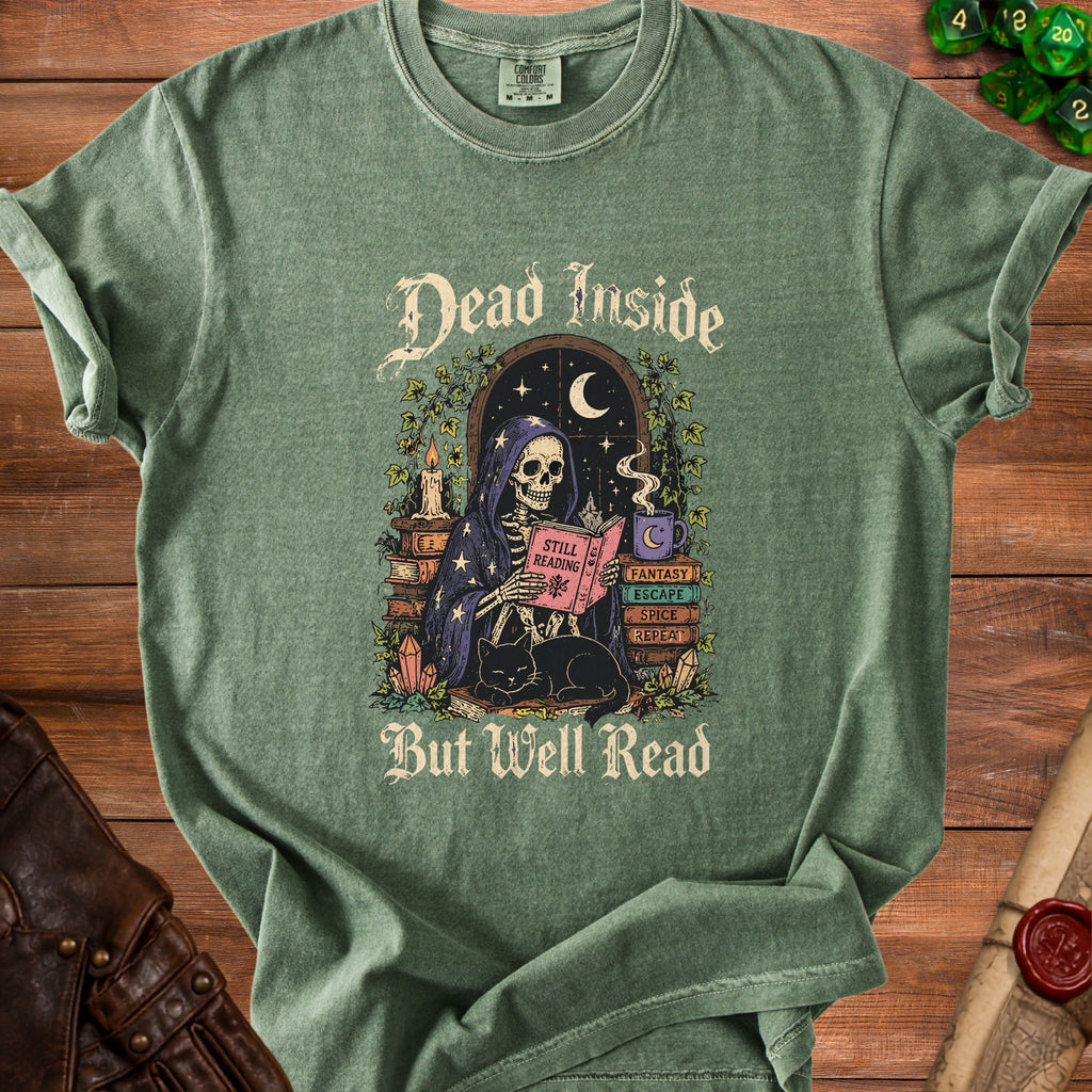 Green t-shirt with skeleton reading surrounded by books and a cat.