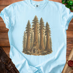 Light blue t-shirt with a graphic of wizards and a jack-o'-lantern in a redwood forest.