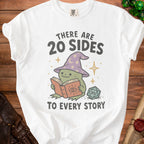 White t-shirt with a graphic of a frog reading a book and a D20 die.