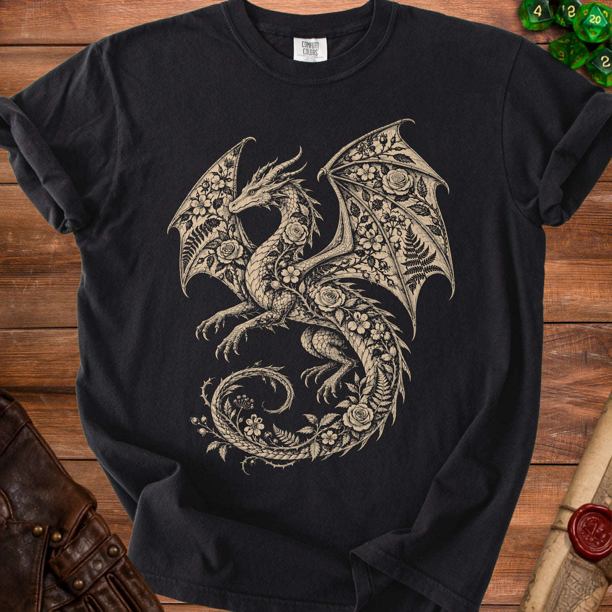 Black t-shirt with a beige dragon design adorned with roses and ferns.