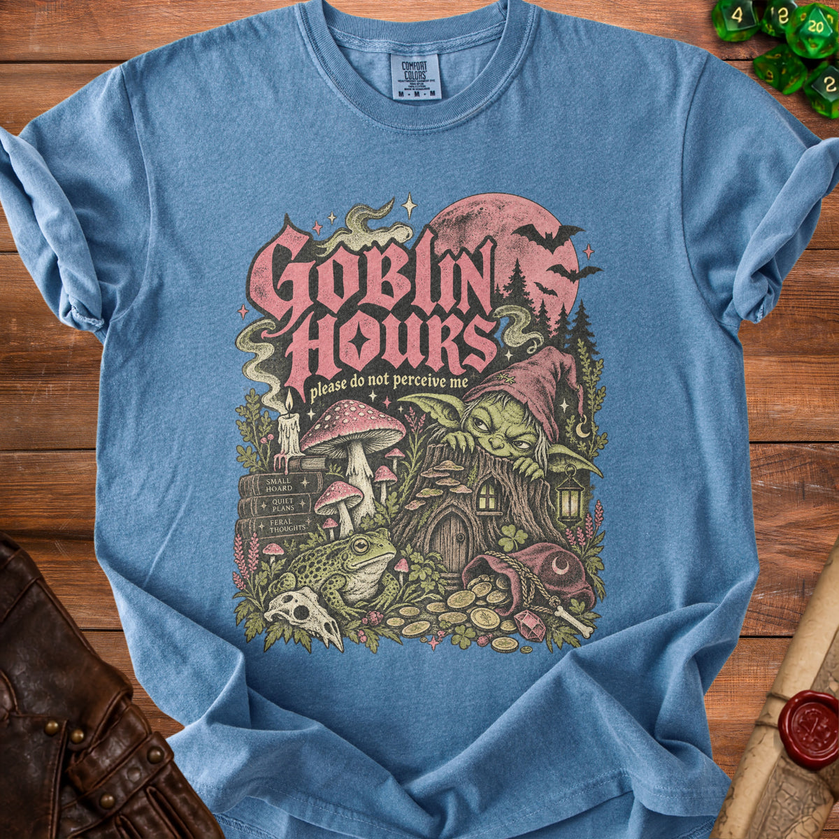 Blue t-shirt with "Goblin Hours please do not perceive me" graphic featuring a goblin.