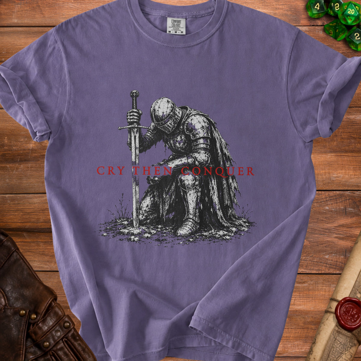 T-shirt with knight kneeling before sword, text "Cry Then Conquer".