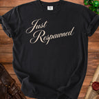 Black t-shirt with cream script text reading "Just Respawned".