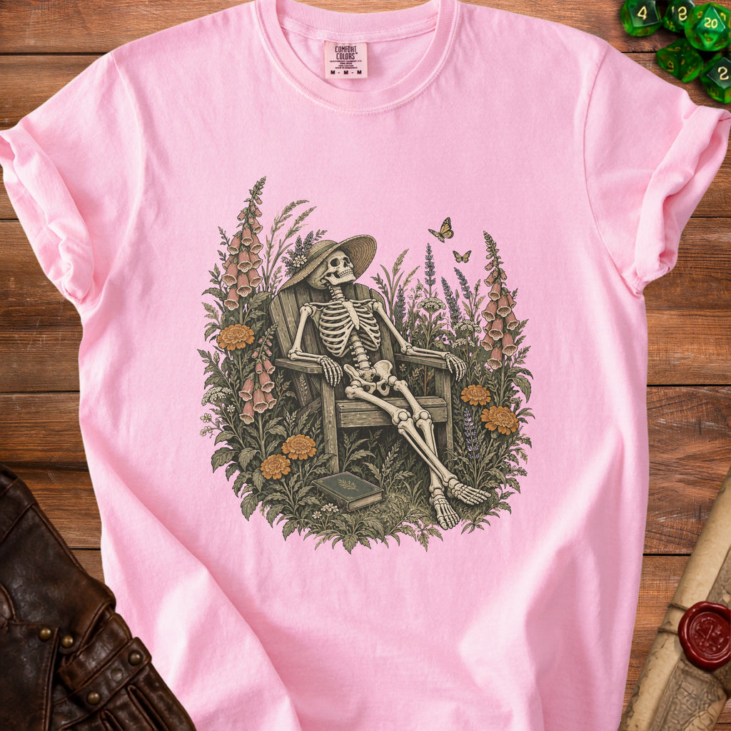 Skeleton wearing a hat sitting in a chair among flowers with butterflies.