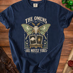 Navy t-shirt with a moth, crescent moons, stars, and tarot cards with "The Omens Are Mostly Vibes" text.