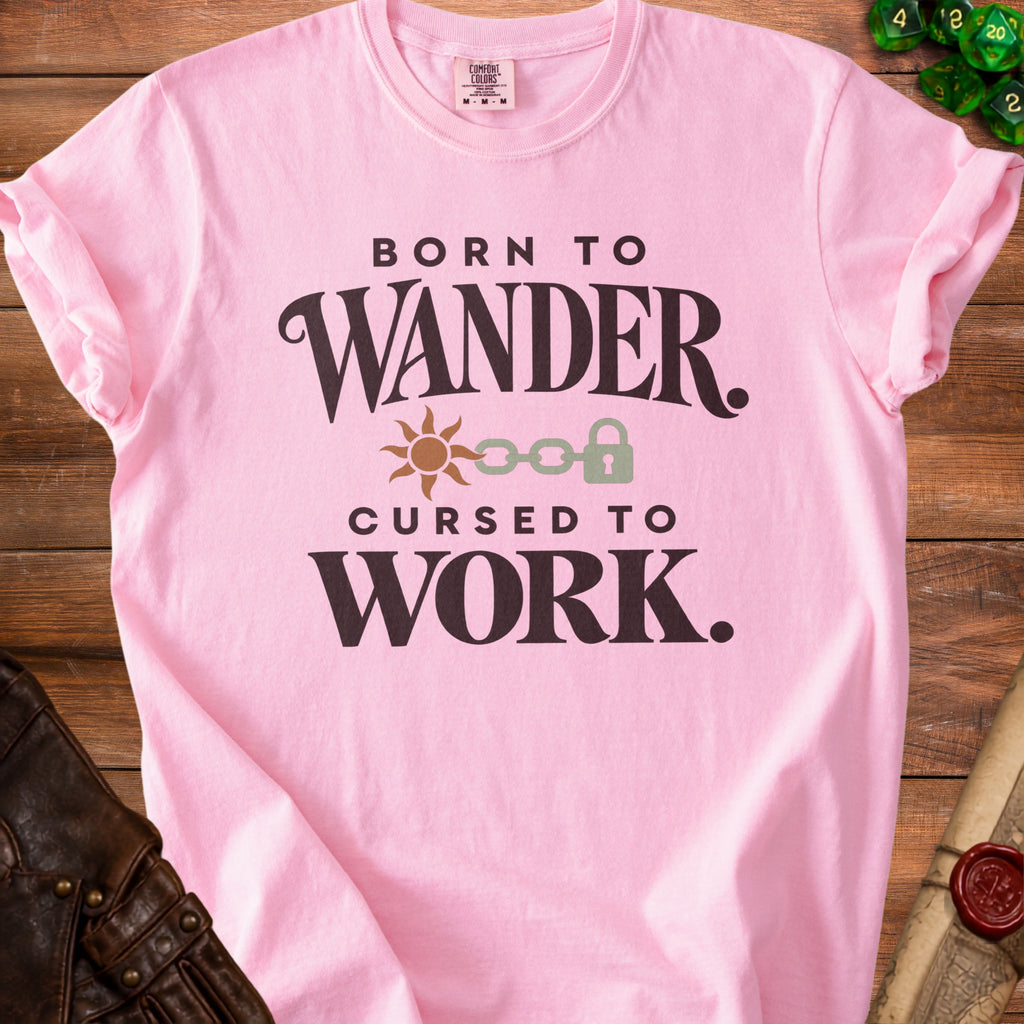 Pink t-shirt with "Born to Wander. Cursed to Work." text and sun and lock graphic.