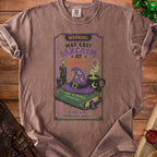T-shirt with "Warning: May Cast Sarcasm At Will" graphic, book, hat, and candles.