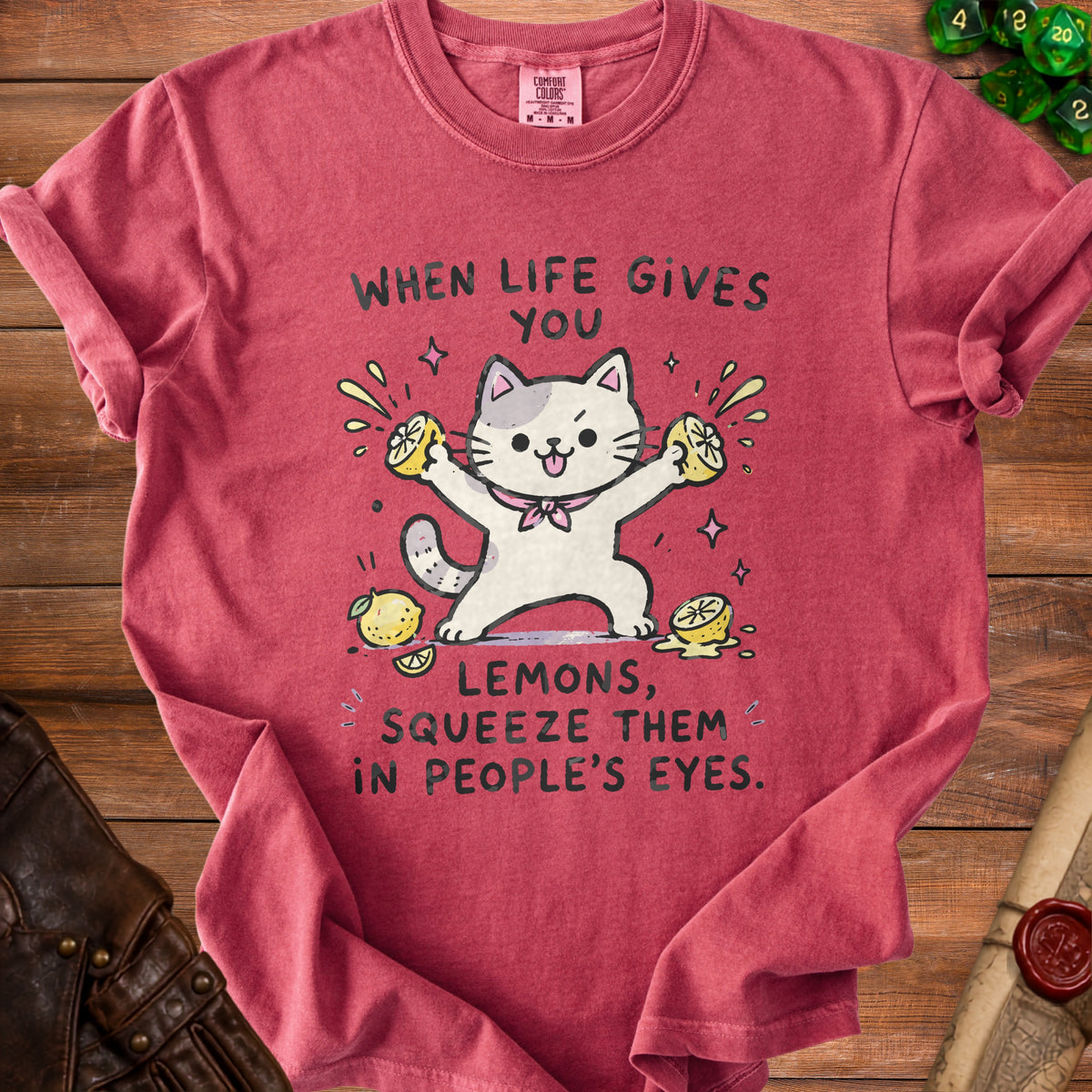 Red t-shirt with a cartoon cat squeezing lemons, text says "When life gives you lemons, squeeze them in people's eyes."