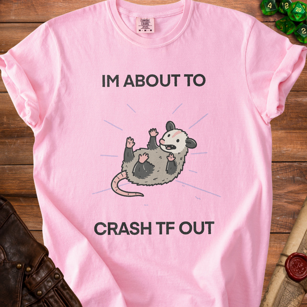Pink t-shirt with a cartoon possum and text "IM ABOUT TO CRASH TF OUT".