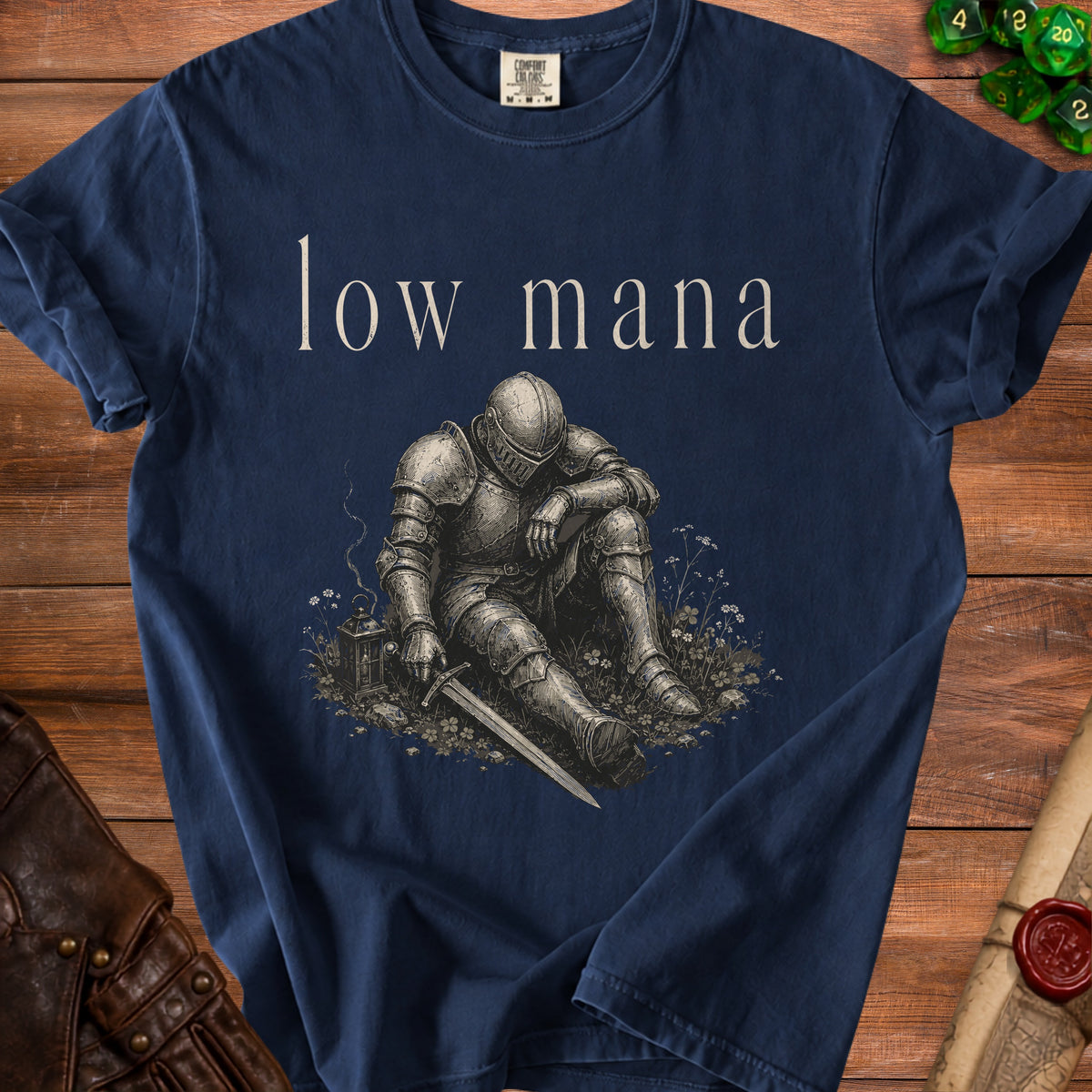 Dark blue t-shirt with "low mana" text above a knight sitting in grass with a sword.