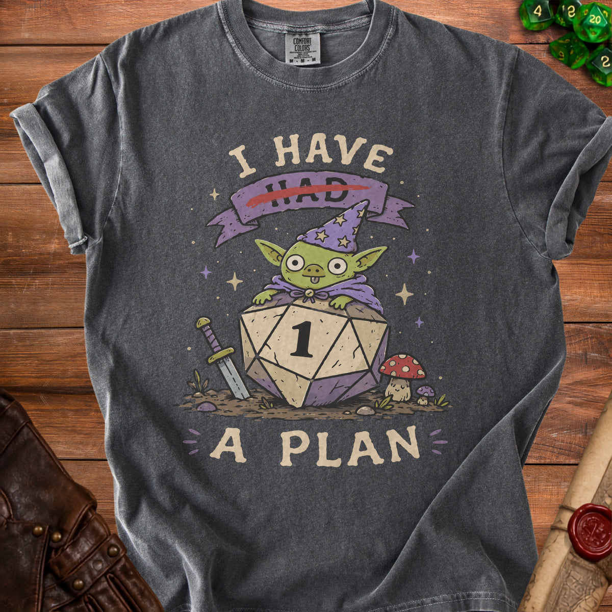 Dark gray t-shirt with a green creature on a d20 die, reading "I HAD A PLAN".