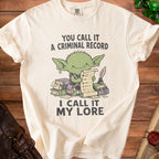 Cream t-shirt with green goblin graphic reading "You call it a criminal record, I call it my lore."