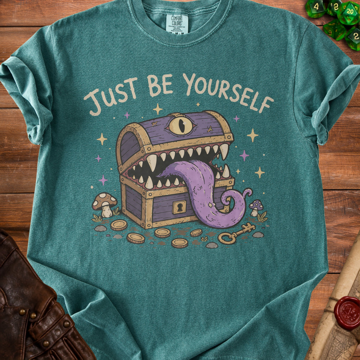 T-shirt with "JUST BE YOURSELF" and a monster treasure chest design.