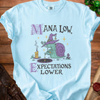 Light blue t-shirt with "Mana Low, Expectations Lower" text and a snail wizard graphic.