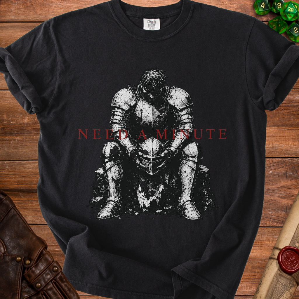 Black t-shirt with a knight holding a helmet and text "NEED A MINUTE".