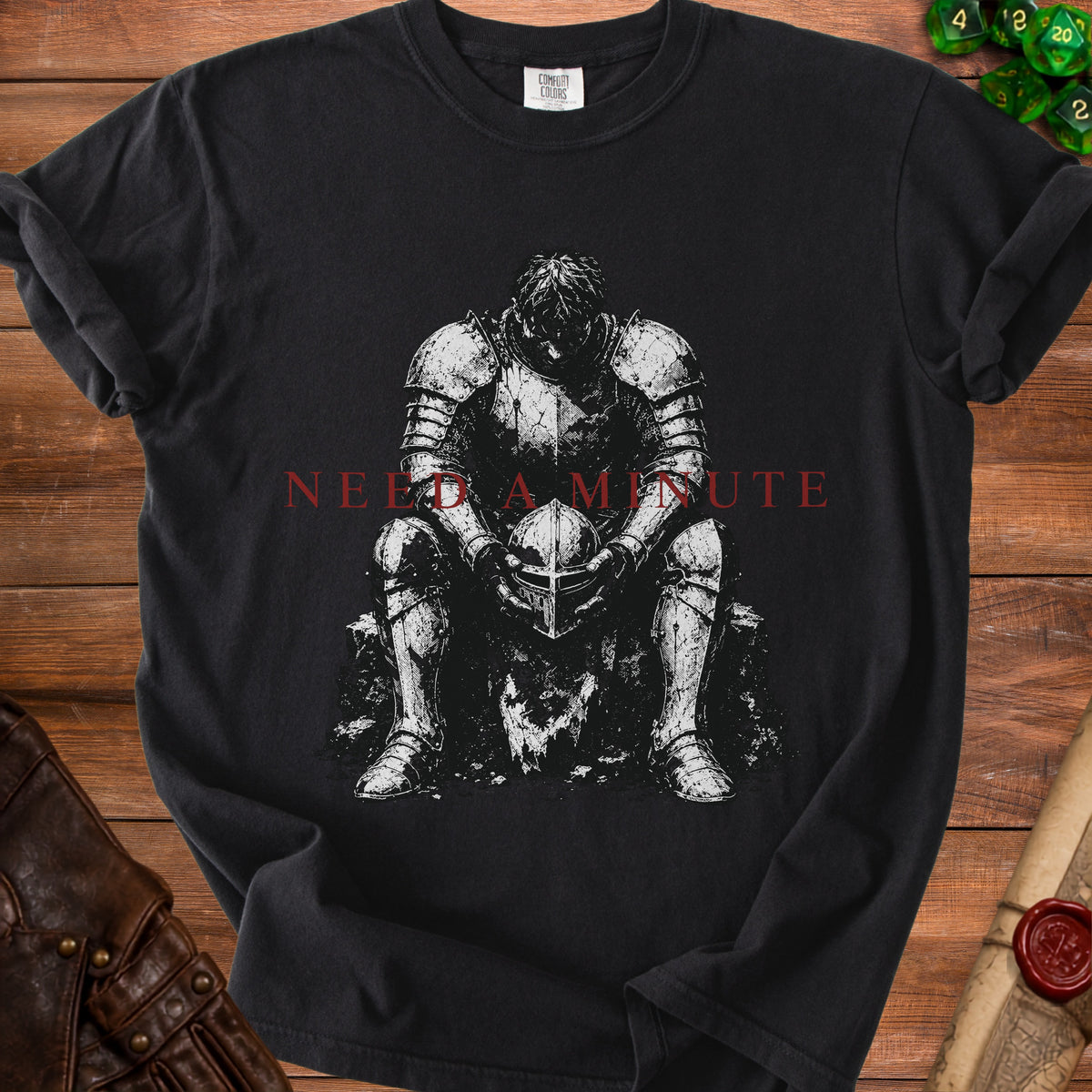 Black t-shirt with a knight holding a helmet and text "NEED A MINUTE".