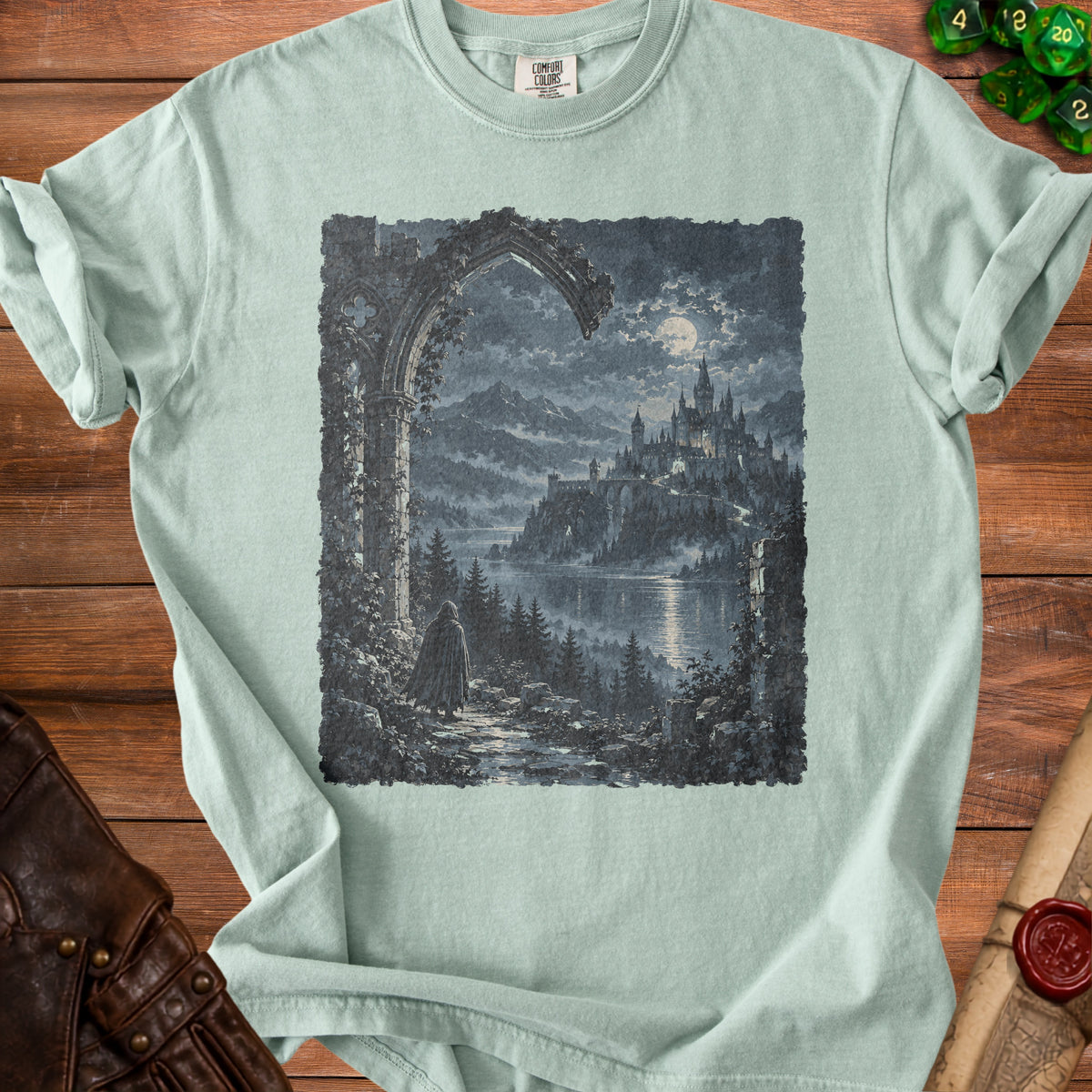 T-shirt with a dark, fantasy castle landscape graphic under a full moon.