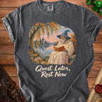 T-shirt with wizard reading by a lake and text "Quest Later, Rest Now".