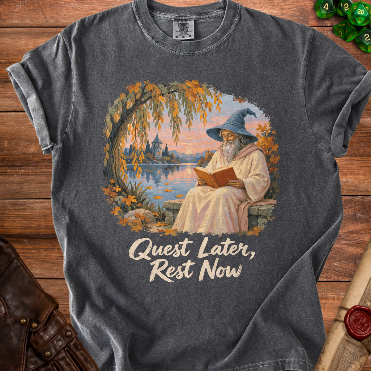 T-shirt with wizard reading by a lake and text "Quest Later, Rest Now".
