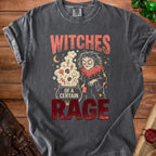 Gray t-shirt with a witch stirring a cauldron, text reads "WITCHES OF A CERTAIN RAGE".